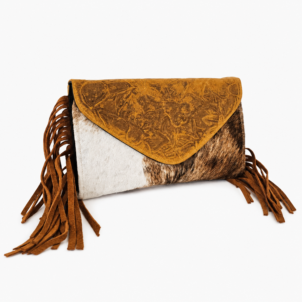 A western-style clutch bag featuring a textured mustard yellow embossed flap, a white and brown cowhide body, and long brown suede fringe on the sides, set against a plain white background.